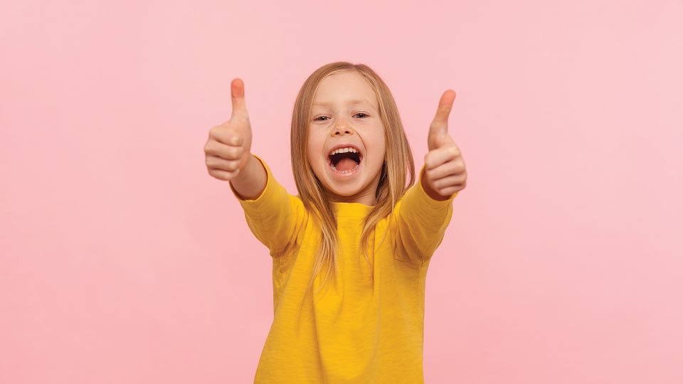 Happy child with thumbs-up